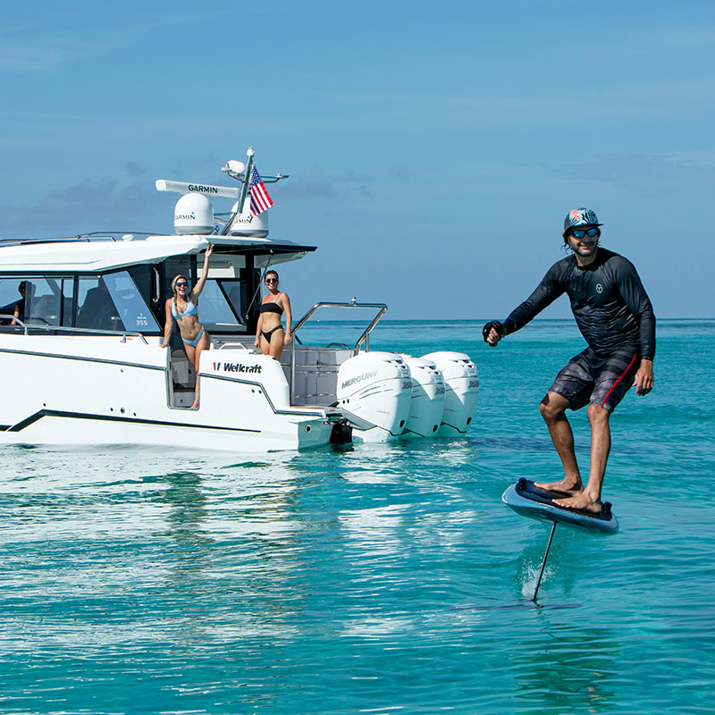 man with water toys by wellcraft boat